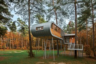 The cabin's curved zinc shell exudes a rugged, industrial look.