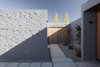 Rusticated clay bricks form the home's unbroken façade, anchoring it to the site and creating the sense of “weight and permanence” the owners desired. The small building blocks added charm and texture, while allowing for a constantly shifting interpretation of scale throughout the project. Photo of Lake Hawea Courtyard House modern home