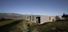 The living, dining, and sleeping spaces occupy the northern and eastern edges of the house, following the direction of the southern hemisphere sun. Niches and overhangs in the building protect it from the hot, dry summers and harsh winters. Photo 2 of Lake Hawea Courtyard House modern home