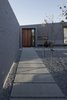 With its expansive, geometric design and wide concrete-slab walkways, the enclosed central courtyard around which the house is organized creates outdoor space protected from the sometimes-inhospitable wind out of the northeast. Photo 8 of Lake Hawea Courtyard House modern home