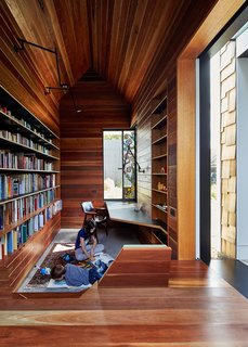 The library is lined in reclaimed spotted gum that Maynard says "brings with it wisdom from its previous life." A stained glass window by Leigh Schellekens makes the contemplative room feel like a domestic chapel.