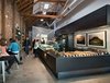 Modern home with Dining Room, Stools, Table, Bar, Recessed Lighting, and Concrete Floor. Housed in a brick and timber Mission building that saw past lives as both a hotel and auto repair shop, Craftsman and Wolves was created by founder and chef William Werner using simple materials and a relatively modest budget. Werner collaborated closely with Zack | de Vito Architecture + Construction to bring to light his vision for a modern pâtisserie that was masculine and industrial. A cool-toned interior palette is favored, with black quartz counters at the bar and steel-trowel stucco cement walls along the kitchen's perimeter. Modest IKEA cabinetry is seamlessly integrated with custom Italian glass refrigerated pastry cases. 746 Valencia Street Photo of The 10 Best-Designed Coffee Shops in San Francisco