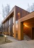 Larch timber planks make up the reddish-gray facade and also adorn the interior walls and floor. Zhidkov says the wood "allowed the house to be an organic insertion into the landscape." Photo 2 of House in Moscow modern home