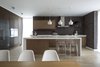 "The interior design is restrained, sometimes minimalist, but very expressive," Zhidkov says. The space is outfitted with modern pieces like the Eames Eiffel chairs, lucite bar stools, and geometric pendant lights. Photo 4 of House in Moscow modern home
