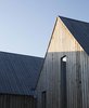 Modern home with Exterior, House, and Gable RoofLine. With their matching peaked roofs, every cabin nods to the traditional form of countryside retreats. The cluster’s pine cladding has been treated to speed up the aging process, giving it a warm patina. Photo of This Cozy Retreat Holds the Cure for Cabin Fever