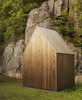 Modern home with Exterior, Gable RoofLine, Wood Siding Material, and Cabin Building Type. A shed provides storage for the owners’ tools as well as wood for the fireplace. It features the same aged pine finish as the main home. Photo of This Cozy Retreat Holds the Cure for Cabin Fever