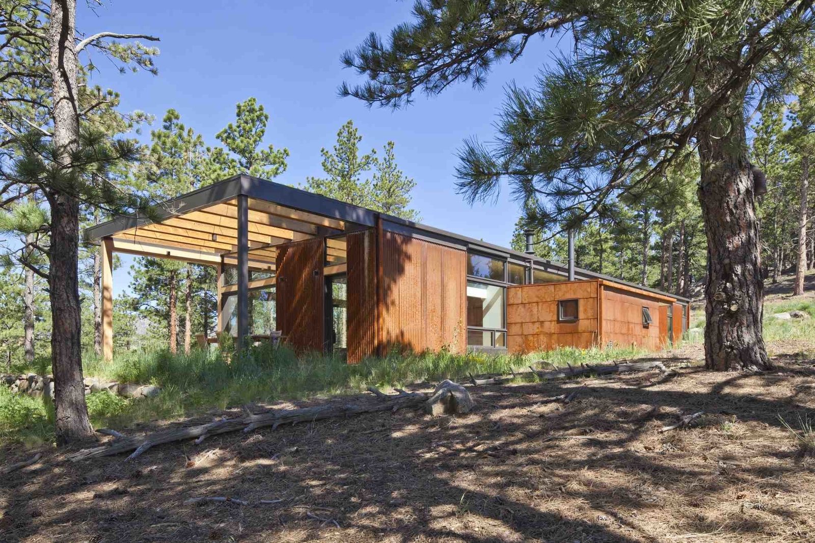 A high band of windows on the east side of the home lets light in, while a simple wood overhang shades an outdoor dining area on the terrace with mountain views. "On clear days, it feels like you can see across the high plains to Kansas," says Hirsh. 

Photo by Ron Johnson.