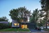 Modern home with Exterior, House Building Type, Wood Siding Material, and Flat RoofLine. An entire floor was added to the house, and the garage was updated. Photo of Sleek Renovation on a Tree-Lined Street in Quebec City