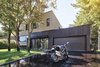 Modern home with Exterior, House Building Type, and Metal Siding Material. The exterior mixes pale gray wood on the vertical volume, and fiber cement and black brick on the horiztonal volume. The three trees in the front yard were maintained during the renovation process. Photo of Sleek Renovation on a Tree-Lined Street in Quebec City
