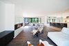 Modern home with Living Room and Recliner. The dining table in the open-plan space is custom, and the fireplace is from Napoleon. Photo of Sleek Renovation on a Tree-Lined Street in Quebec City
