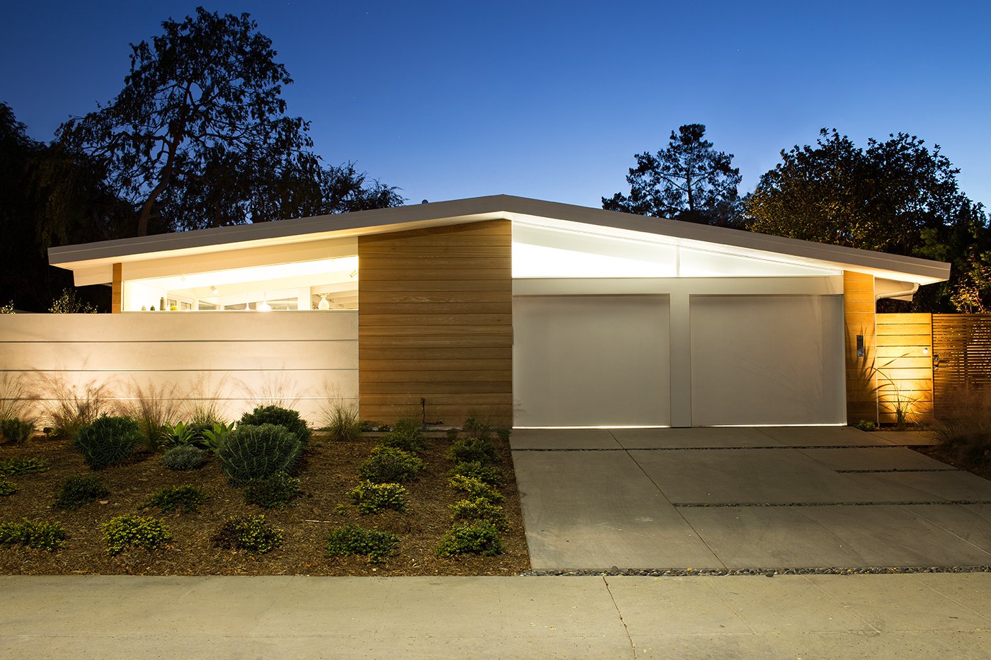 From the street, the home bears many of the hallmarks of an Eichler home. Its low roofline is in large part supported by glass walls. Clear cedar siding provides additional warmth. The exterior tiles used around the house are actually custom poured concrete from RJ & Associates Landscape Specialists.