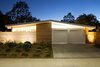 Modern home with Exterior, House Building Type, and Mid-Century Building Type. From the street, the home bears many of the hallmarks of an Eichler home. Its low roofline is in large part supported by glass walls. Clear cedar siding provides additional warmth. The exterior tiles used around the house are actually custom poured concrete from RJ & Associates Landscape Specialists. Photo of Modern Master: Joseph Eichler