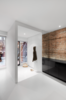 Modern home with Hallway. The semi-closed entryway contains a white cabinet for storing coats and scarves. The LED ceiling lights are from Contrast Lighting. Photo of A Futuristic Apartment with a Glass-Enclosed Bedroom