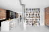 Modern home with Kitchen and White Cabinet. The steel beam original to the building was left exposed but toned down with gray, flame-proof paint. It runs the length of the flat, delimiting the passage area. Photo of A Futuristic Apartment with a Glass-Enclosed Bedroom