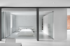 Modern home with Bedroom and Bed. The bedroom is enclosed with a glass wall. A blackout curtain can be drawn closed for privacy. An Ikea cabinet and custom white lacquered shelves provide plenty of closet space. Photo of Unusual Sleeping Spaces