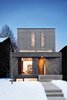 Modern home with Exterior and House Building Type. Composed of 220 aluminum "light shelves," the solar reflector screen is the focal point of the front façade. The home takes advantage of its Southern exposure, using the reflector screen to funnel sunlight and warmth deep into the interior space. Photo of A Modern Toronto House Covered by a Contemporary Solar Screen