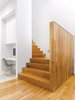 Modern home with Staircase and Wood Tread. "We composed the house to have its highest, brightest space in the middle," says Paul Raff. Warm wood stairs lead to the second floor, which houses guest bedrooms, bath, and a kitchenette for the family's frequent visitors. Photo of A Modern Toronto House Covered by a Contemporary Solar Screen