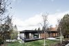 Carle revived the home’s exterior by recladding it in fresh cedar planks, local stone, and black anodized aluminum. He also replaced the original windows — all damaged — and changed the sizes of some to respond better to the outdoors. Photo of The Phoenix modern home
