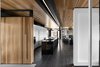 Cedar planks and gray-stained oak flooring line the interior. A minimalist LED lighting strip by Systemalux runs through the kitchen area, enhancing the wood ceiling’s reddish tone. Photo 4 of The Phoenix modern home
