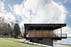 The original design did not exploit the lower part of the house, so Carle added a bar and lounge area facing the lake at the ground level. He also installed water-based geothermal heating in the basement. “It allows the concrete floor to be heated and to generate most of the heating of the house, while a second smaller air pump assures a supplement of air on the ground floor and air conditioning for summer.” Photo 6 of The Phoenix modern home