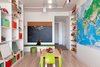 The kids' playroom features built-in storage and a Fly pendant from Design Within Reach. Reddy purchased the mural from World Maps Online and the small table and chairs from Igloo Play. Photo of How to Design With Maps modern home