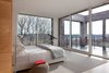 Ciavarra used floor-to-ceiling glass for the master bedroom, which leads onto a deck. Photo 7 of Watch Hill modern home