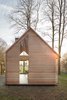 Modern home with Exterior, Cabin Building Type, Shingles Roof Material, Wood Siding Material, and House. The house may appear conventional at a glance, but a closer look shows how Oostenbruggen has pushed the boundaries of the traditional gabled typology. It has an asymmetrical roof, with slate shingles that extend down the eastern side to close it off completely. Photo 2 of Utrecht Cabin