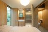 Modern home with Bath Room and Enclosed Shower. In the bedroom, a door opens directly to the stainless steel shower. A half-bath sits just outside the bedroom, allowing guests easy access to it when the wood panel dividing the bedroom from the main area is drawn. The sinks are by Duravit and faucets by Grohe. Photo 8 of Utrecht Cabin