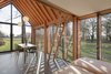 Modern home with Dining Room, Table, Chair, and Pendant Lighting. The house's ceiling was hewn from Douglas fir, which gives off a warm glow. The rafters were designed to emulate the look of strong ceiling beams. Photo 9 of Utrecht Cabin