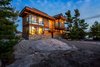 Beside the Georgian Bay in Ontario, architect and partner at Toronto's CORE Architects Charles Gane built a 2,100-square-foot getaway for himself that combines urban building practices with rugged self-sufficiency. The aluminum window system and flat roof are common characteristics of Toronto's high-rises, while the cedar shingles belong to cottage vernacular. Photo of Monument Channel Cottage modern home