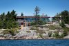 Though it is spacious and modern, Gane's cottage functions entirely off-the-grid. Sewage is treated on-site, water is filtered from the lake and cleansed with ultraviolet light, and an impressive solar array provides energy with battery storage. Photo 5 of Monument Channel Cottage modern home