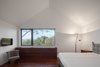 The bedrooms are located on the more sheltered east side. They function as private, closed boxes, as opposed to the more open living room and dining areas. Photo 6 of House of Four Houses modern home