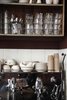 In the open kitchen, stacks of cups wait to be filled, machines wait to serve piping hot beverages, and spoons ready to stir. Photo by: Stine Christiansen Photo of World's Smallest Hotel and Café in Copenhagen modern home