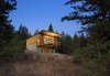 Modern home with Exterior, House, Cabin Building Type, Shed RoofLine, Concrete Siding Material, and Wood Siding Material. While it was tempting to embed the cabin into the hillside, Balance Associates sought a smarter solution. By elevating the project on two concrete walls, the clients could avoid a costly foundation, improve their view of the landscape, and stay above the thick winter snowfall. Photo of Simple Cabin Embraces Its Mountain Setting