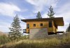 The cabin is clad in clear-stained exterior-grade plywood that’s economical and blends in with the area’s foliage in summer. Photo of Simple Cabin Embraces Its Mountain Setting modern home