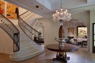 The mansion entry hall includes a large staircase that allows the customer to meander through multiple floors.