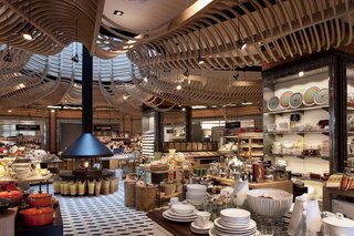 Upon entering the store, the customer is transported into a busy market, much like those in Mexico, where he or she can purchase food products, housewares, utensils, etc. The space is brought up to date through the scupltural wood canopy that moves the eye toward the center of the space.