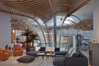 The wood sculpture from the market continues up through the second floor and provides a dynamic backdrop for the contemporary furniture area.