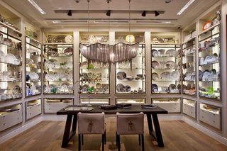 The tableware collections are showcased in a modern interpretation of a classic butler’s pantry with indirect lighting and polished stainless steel frames.