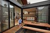 Modern home with Outdoor, Wood Patio, Porch, Deck, and Small Patio, Porch, Deck. The architects pulled away the roof at the house’s center to create a courtyard where the residents can enjoy meals. The ground sits below floor level, which means that the wraparound eucalyptus deck can also serve as a bench. Photo 4 of M House