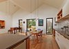 Thanks to the extra space, the clients were able to bring their baby grand piano out of storage. It now sits in the main room, overhung by Mega Bulb pendants from Great Dane. Photo 6 of M House modern home