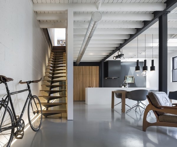 When Jean-Guy Chabauty and Chris Barrie of Atelier Moderno began tackling the space, they decided to stay true to the character and grace of the old autobody shop. "We wanted to retain the spirit and the grit of the original space as much as possible, while creating something modern, comfortable, and alluring," says Barrie. "Sometimes you really need to work to get that character." After playing with a few options for the 1,600-square-foot building, they decided to keep the existing envelope untouched, instead focusing the bulk of the $250,000 renovation project on building out an open interior that included reclaimed and rich materials.