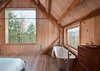 “Structure, rather than decorative elements, provides visual appeal,” Cook says. “The slats create interesting shadows and texture.” Photo of An Eco-Friendly New Hampshire Home Stands Out for its Simplicity modern home