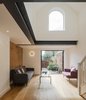 "The natural wax finish oak timber floor boards," write the architects, "create a soft and inviting sense of warmth within the space." Photo of We Love This Adorable Writer's Studio Camouflaged as a Coach House modern home