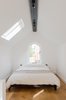The bed is located just behind the desk. Photo of We Love This Adorable Writer's Studio Camouflaged as a Coach House modern home