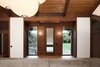 Modern home with Windows. The building’s character is defined by the texture and color of its exposed wood. The clients wished to maintain this unique design feature and the architects worked extensively to repair and maintain the original ebony hues. The oak floors were refinished. The dark brown beams and columns are stained fir; they only required repairs on the exterior. The ceiling is cedar. Photo 2 of Zema Redux