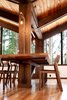 The dining room table previously had an awkward placement around a column. For a more efficient solution, the architects simply embedded the table in the column, using carefully selected wooden supports that would match existing tones. Photo 5 of Zema Redux modern home