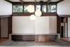 The sloped roof has the added advantage of looking onto the surrounding trees. A large television is concealed behind the wooden panel adjacent to the fireplace. A sleeping loft, seen at right, became possible when the old laundry room was eliminated. Photo 7 of Zema Redux modern home