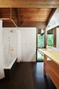 Modern home with Bath Room, Wood Counter, and Drop In Tub. The brass fittings are new to the project but are similar to metal that was originally used elsewhere in the project. The fittings, seen here in the children’s bathroom, will quickly acquire a dark patina. Photo 9 of Zema Redux