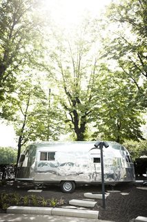 "The Trailer" is a 1952 22-foot Silver Creek Clipper completely converted into a 112 euro-per-night room. The trailer redesign was overseen by Hansjorg Kofler and is referred to as "the island" of the hotel. The Airstream was completely stripped and refitted with thermal insulation, soundproofing, A/C, wifi, and hot water.
